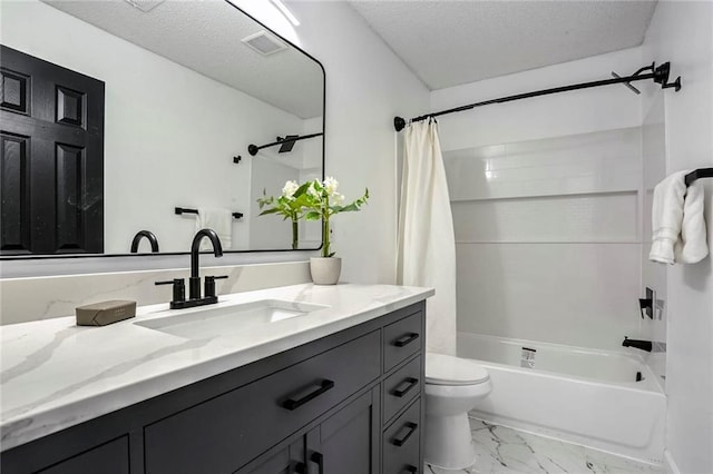 bathroom with a textured ceiling, toilet, vanity, visible vents, and marble finish floor