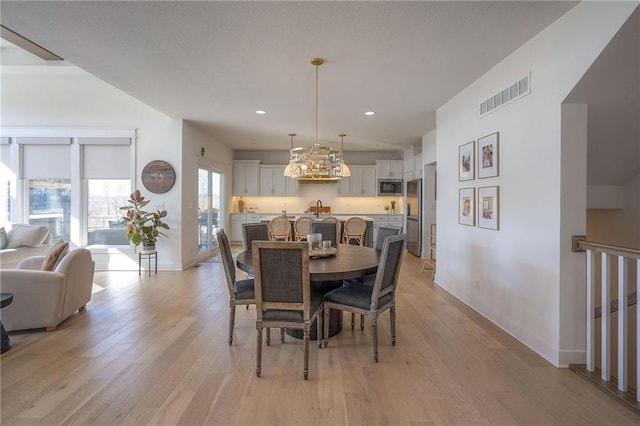 dining area featuring recessed lighting, baseboards, visible vents, and light wood finished floors