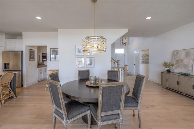 dining space featuring light wood-type flooring, recessed lighting, and stairs