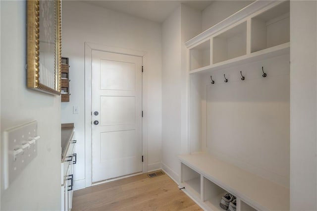 mudroom with light wood finished floors