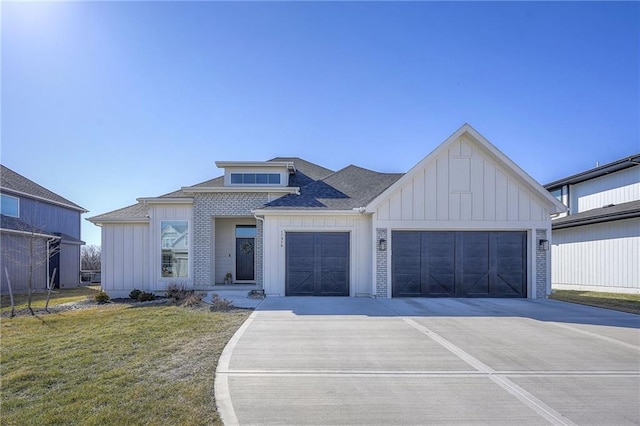 view of front of home featuring an attached garage, driveway, a front lawn, and board and batten siding