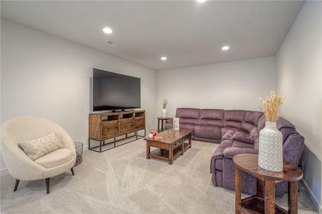 carpeted living area with baseboards and recessed lighting