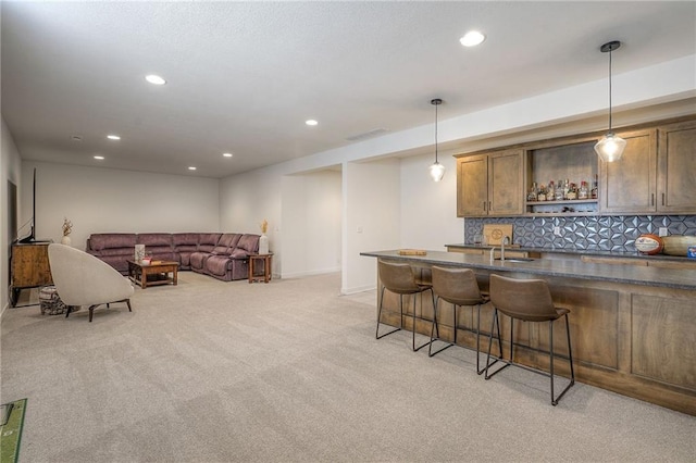 bar with recessed lighting, light carpet, decorative backsplash, indoor wet bar, and pendant lighting