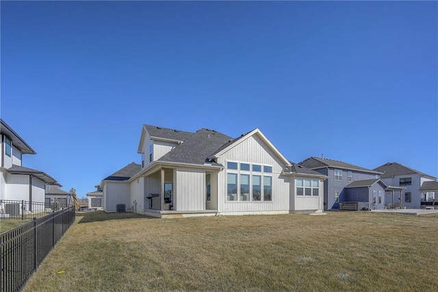 back of house with a yard, central AC unit, and fence