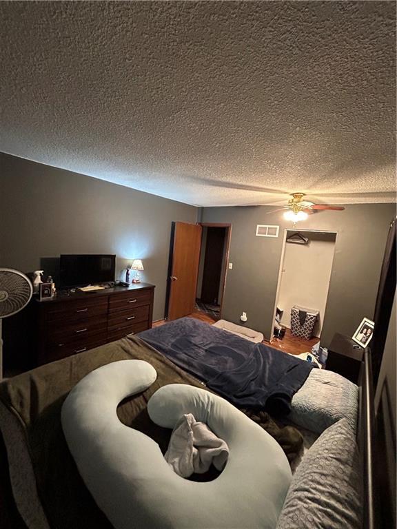 bedroom featuring visible vents and a textured ceiling