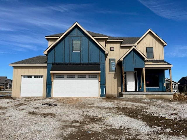 view of front of house featuring board and batten siding, driveway, and a garage