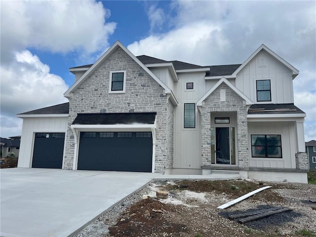 12604 W 170th St, Overland Park, KS 66221 - view of front of house with board and batten siding, stone siding, concrete driveway, and a shingled roof