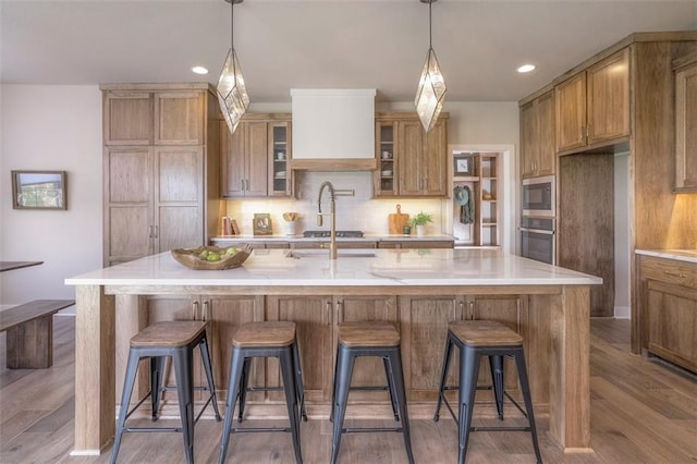 12604 W 170th St, Overland Park, KS 66221 - kitchen featuring appliances with stainless steel finishes, wood finished floors, tasteful backsplash, light countertops, and recessed lighting