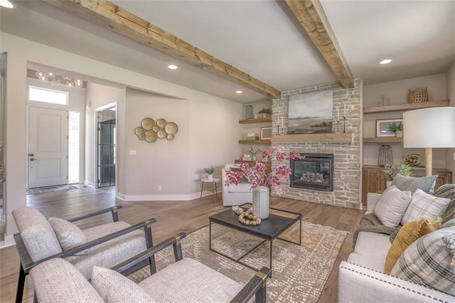 12604 W 170th St, Overland Park, KS 66221 - living room featuring beamed ceiling, a stone fireplace, wood finished floors, and recessed lighting
