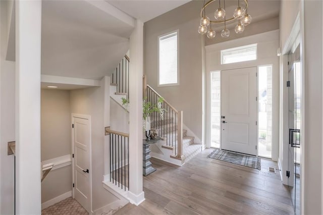 12604 W 170th St, Overland Park, KS 66221 - foyer entrance with wood finished floors, stairs, and a chandelier