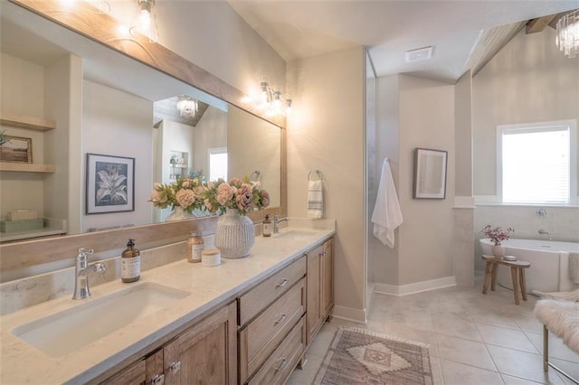 12604 W 170th St, Overland Park, KS 66221 - full bathroom featuring a freestanding bath, double vanity, healthy amount of natural light, and tile patterned floors