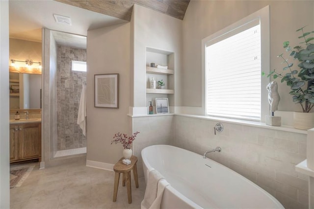 12604 W 170th St, Overland Park, KS 66221 - bathroom featuring vanity, a stall shower, built in features, a freestanding bath, and tile patterned floors