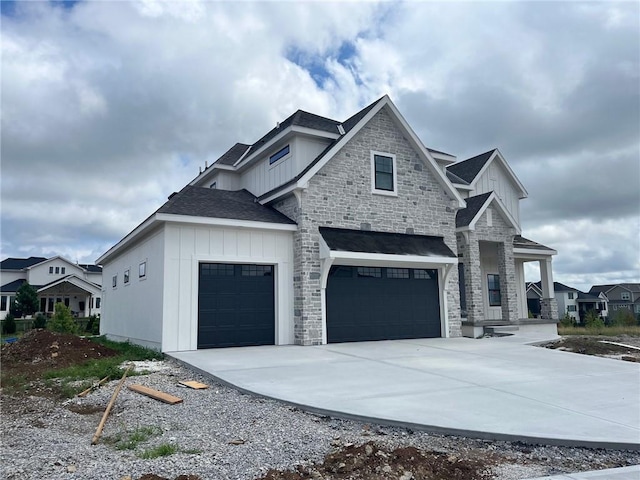 12604 W 170th St, Overland Park, KS 66221 - view of front of home with board and batten siding, stone siding, concrete driveway, a garage, and roof with shingles