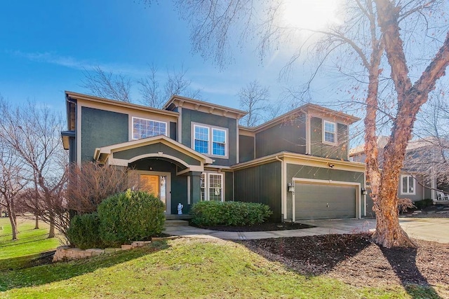 view of front of house with a garage, driveway, a front lawn, and stucco siding