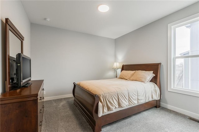 bedroom with carpet flooring, visible vents, and baseboards