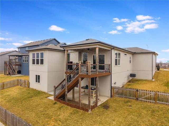 rear view of property with a patio, stairway, a fenced backyard, and a lawn