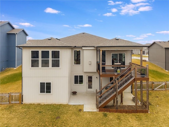 rear view of house featuring a patio area, a gate, stairway, and a yard