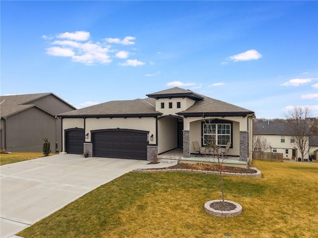 prairie-style home featuring stucco siding, concrete driveway, a garage, stone siding, and a front lawn