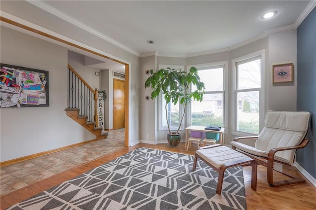 living area with stairway, crown molding, light wood-style flooring, and baseboards