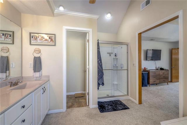 bathroom featuring vanity, a shower stall, visible vents, and baseboards