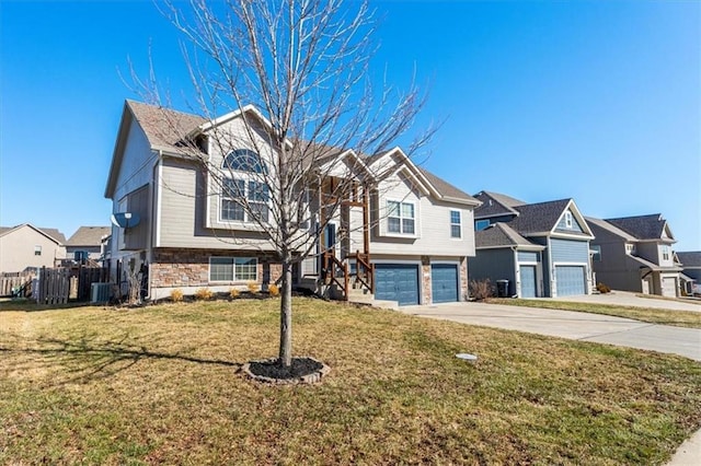 view of front of property featuring a residential view, stone siding, concrete driveway, and a front yard