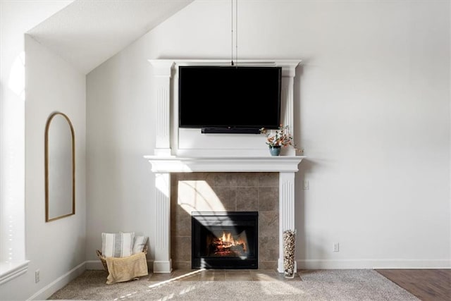 interior details featuring baseboards and a tiled fireplace