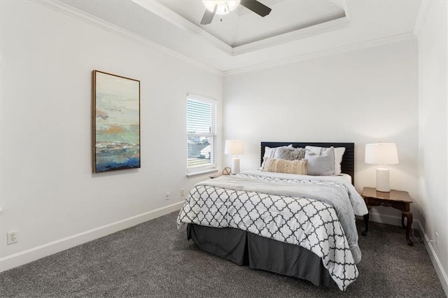 bedroom featuring baseboards, a tray ceiling, carpet, and crown molding