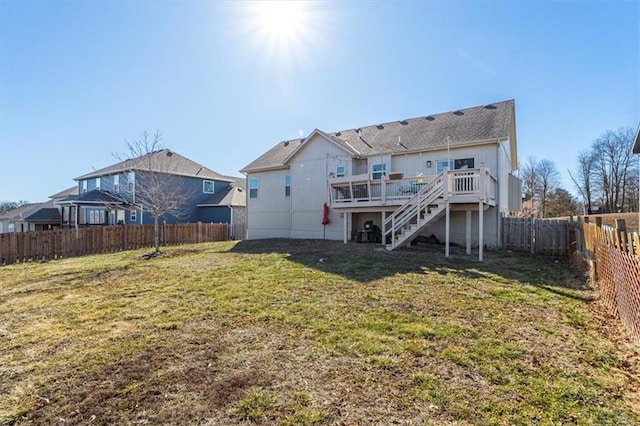 rear view of property with a fenced backyard, a yard, a deck, and stairs