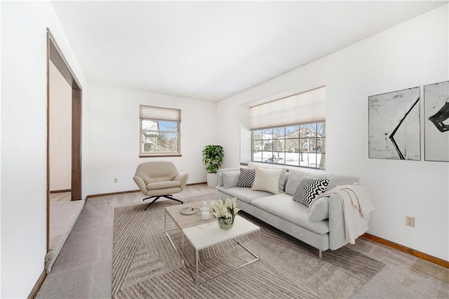 living area featuring carpet floors and baseboards