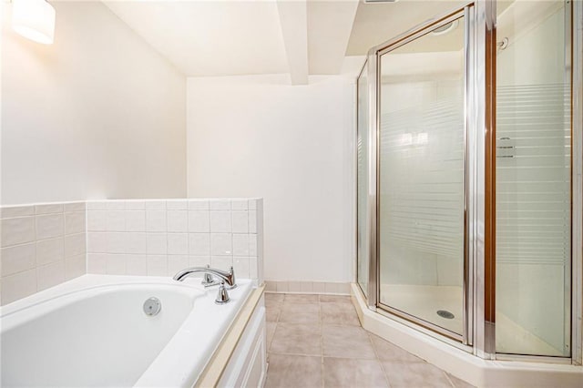 bathroom featuring tile patterned floors, baseboards, a bath, and a shower stall