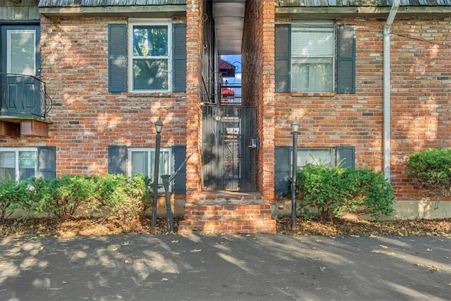 property entrance with brick siding