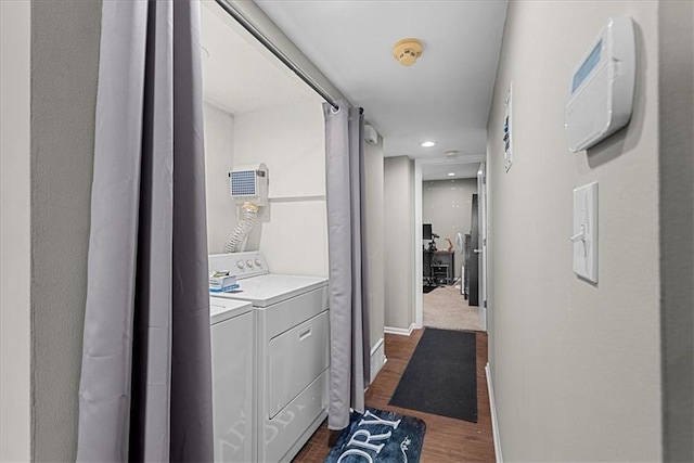 corridor with baseboards, dark wood finished floors, and washer and dryer