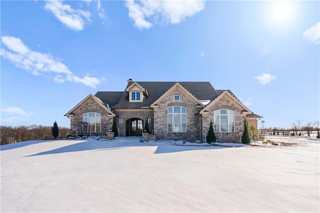 french country style house with a chimney