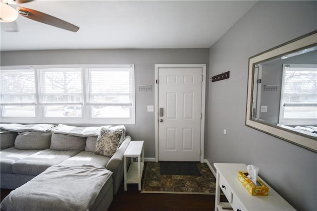 living room featuring ceiling fan and baseboards