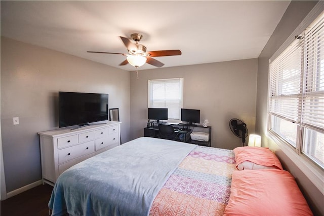 bedroom featuring a ceiling fan and baseboards