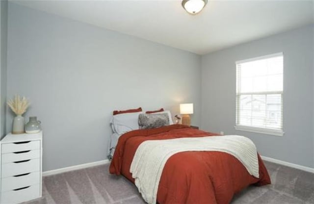 bedroom featuring carpet flooring and baseboards