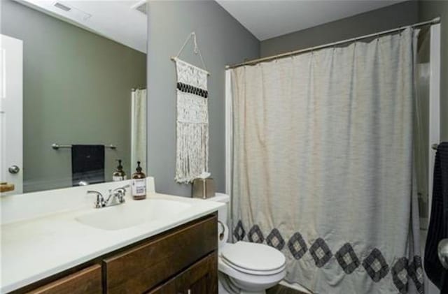 full bathroom with toilet, vanity, and a shower with curtain