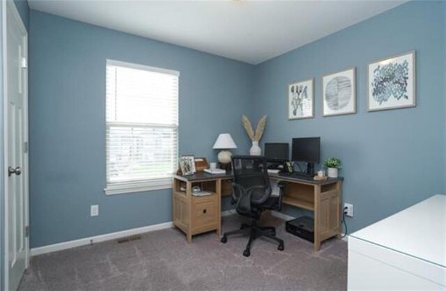 home office featuring baseboards and dark carpet