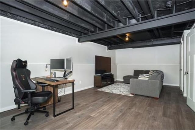 interior space featuring dark wood-style flooring and baseboards