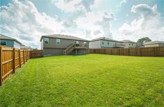 view of yard with stairway and a fenced backyard