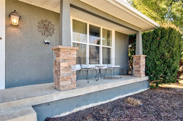 property entrance featuring stucco siding and a porch