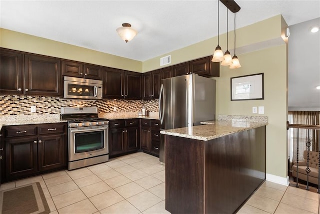 kitchen featuring visible vents, a peninsula, dark brown cabinets, appliances with stainless steel finishes, and backsplash