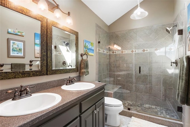 full bath with vaulted ceiling, a shower stall, and a sink