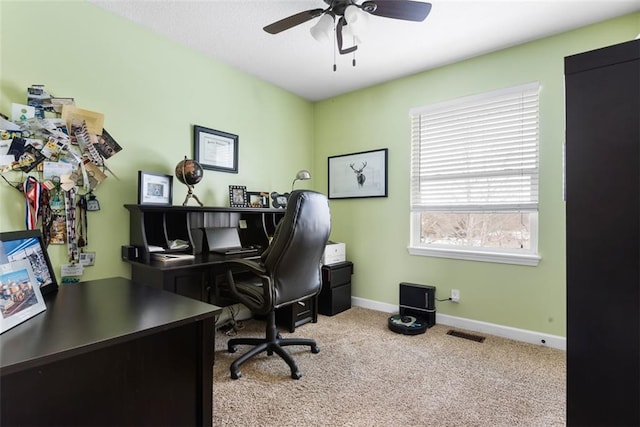 carpeted home office with baseboards, visible vents, and ceiling fan