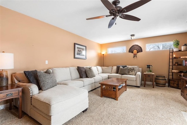 carpeted living room featuring ceiling fan