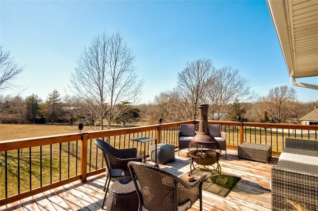 wooden terrace featuring an outdoor fire pit