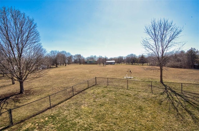 view of yard with a rural view and fence