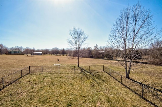 view of yard featuring a rural view and fence