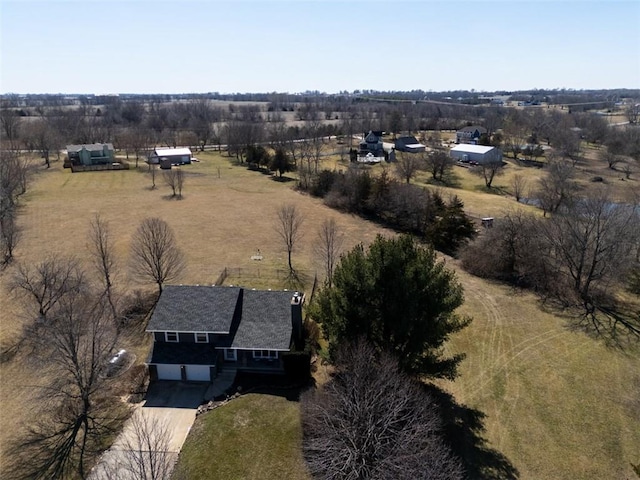 birds eye view of property with a rural view