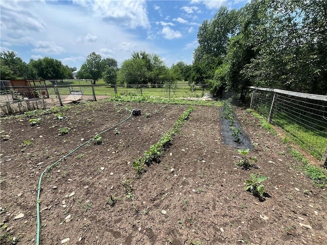 view of yard with a rural view and fence